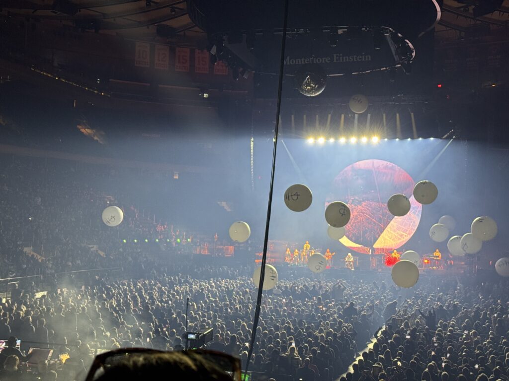 Balls bounce around the crowd st intermission. They are large, about a metre across and are white.